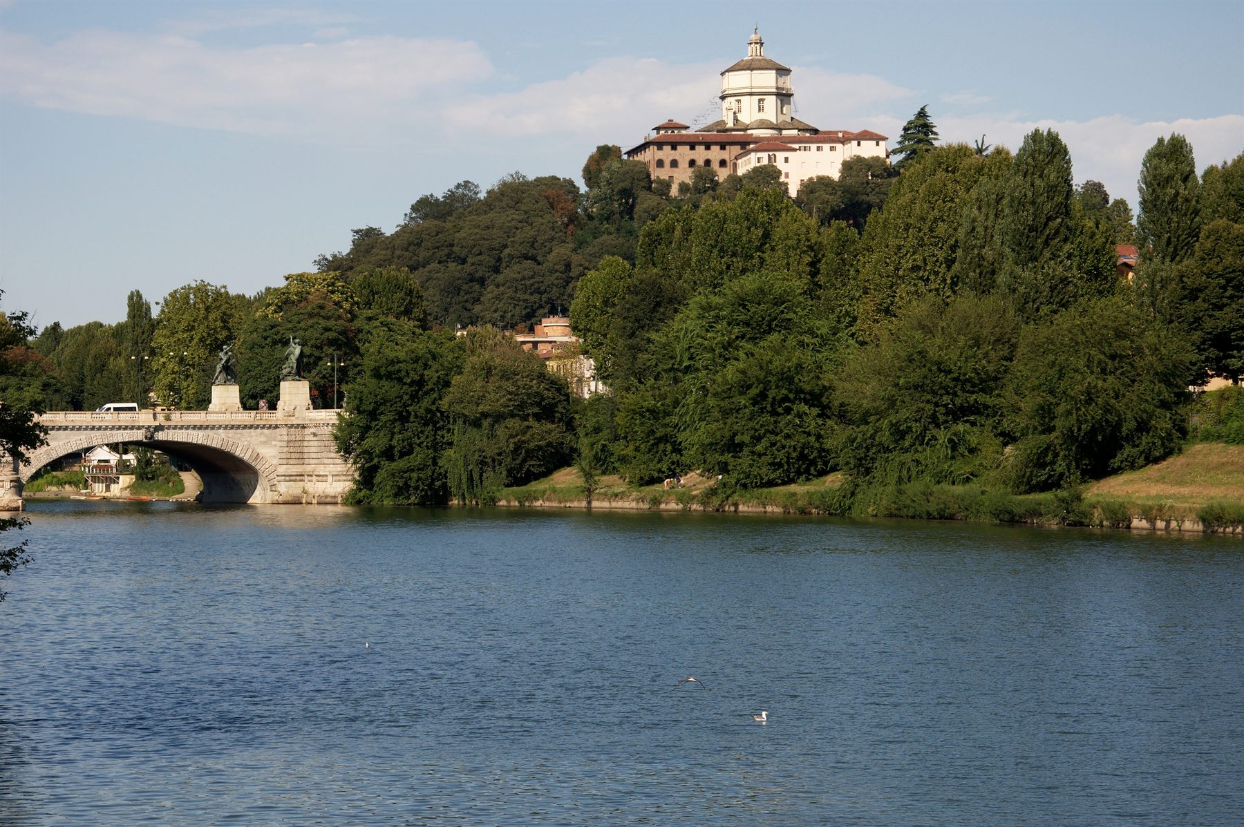 Stone bridge and hilltop church above the Po in Turin