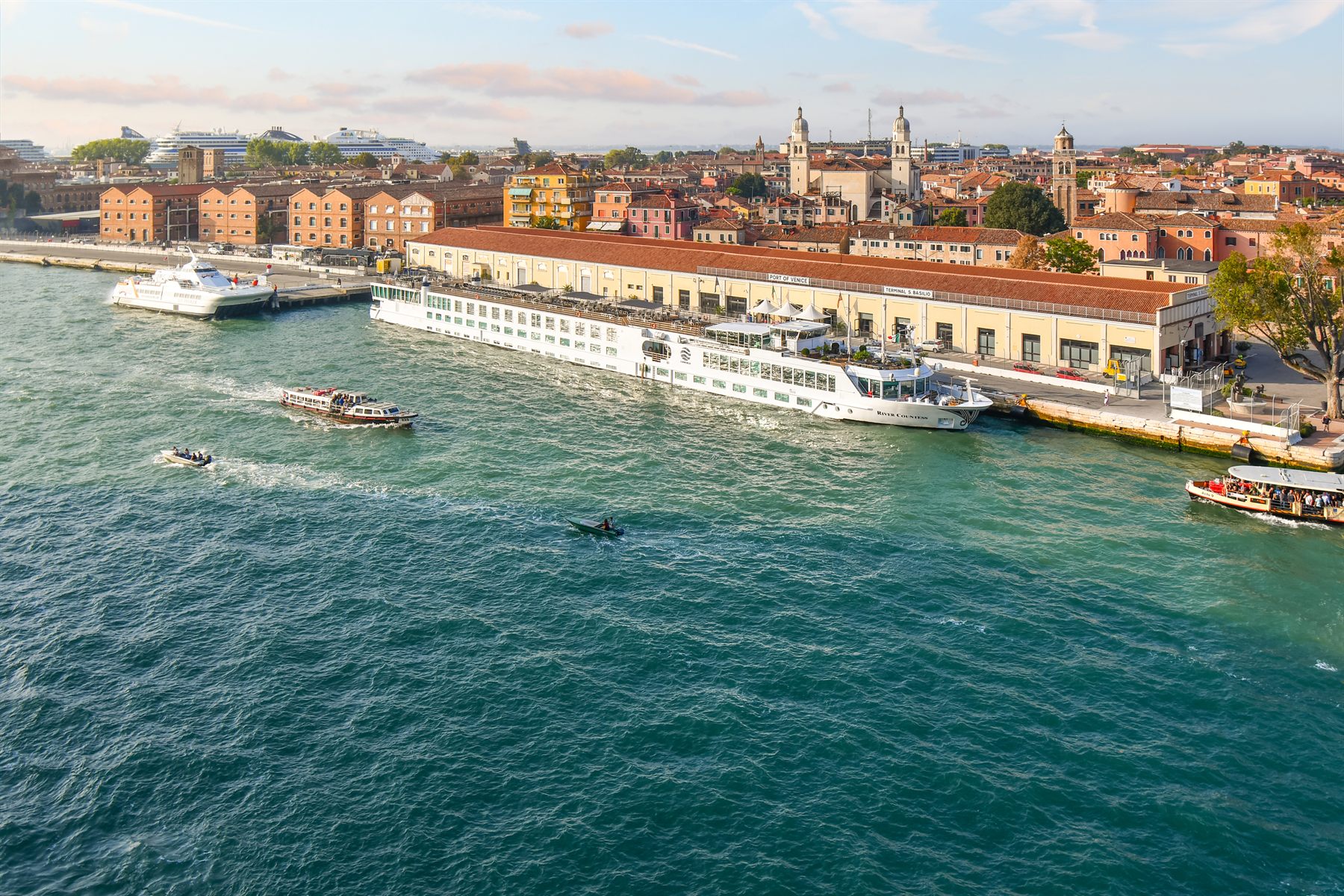 River cruise ship moored on the Venice waterfront beside the old warehouses